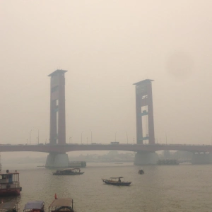 Gloomy Ampera Bridge in the morning covered with fog